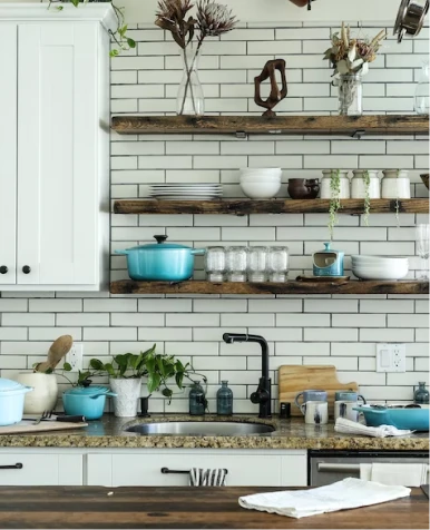 A photo of a kitchen backsplash with a variety of tiles in different colors and patterns.