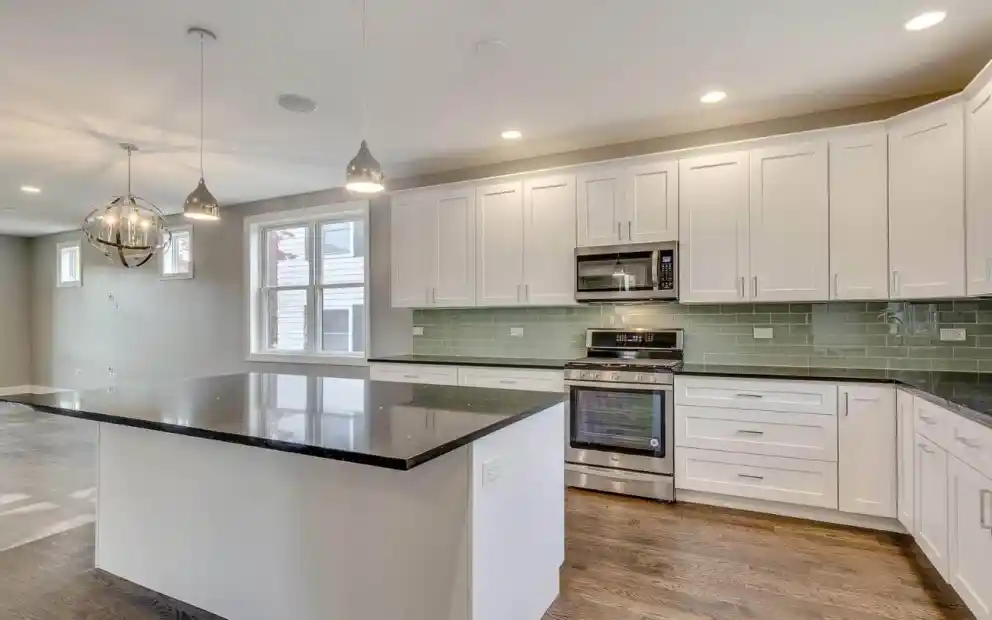 White cupboards with black countertop