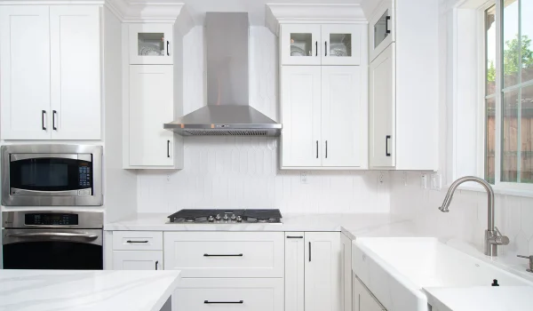 A kitchen with white cabinets and a marble countertop in Upper Arlington, Ohio